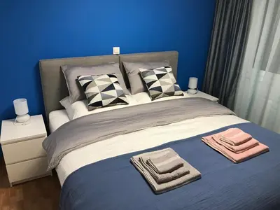 a blue bedroom with a bed with towels on it at Ancient Thissio in Athens
