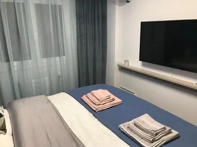 a hotel room with towels on a bed with a flat screen tv at Ancient Thissio in Athens