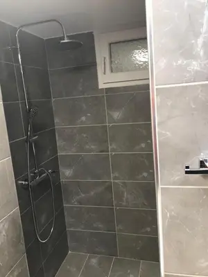 a shower with a glass door in a bathroom at Ancient Thissio in Athens
