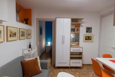 a living room with a couch and a kitchen at Ancient Thissio in Athens
