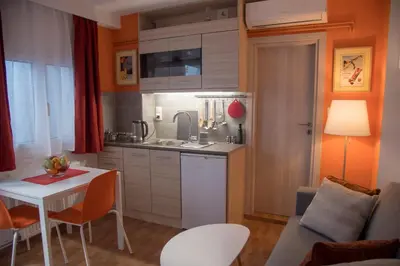 a kitchen with a white table and a table and chairs at Ancient Thissio in Athens
