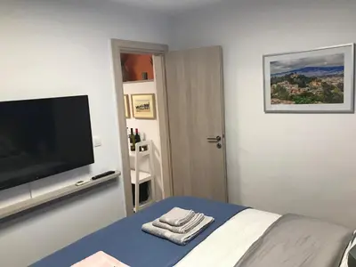 a bedroom with a flat screen tv and a bed at Ancient Thissio in Athens