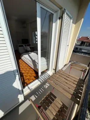 a wooden bench sitting on the balcony of a house at Acropolis View in Athens