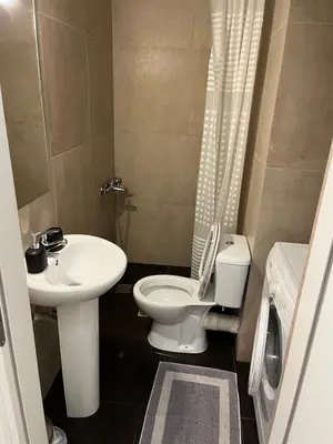 a bathroom with a white toilet and a sink at Acropolis View in Athens