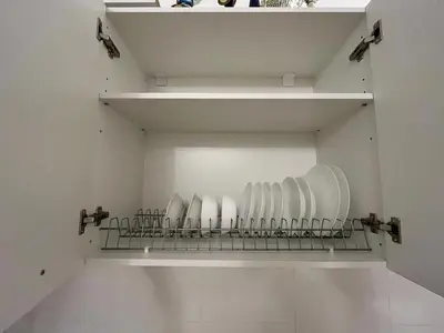 a cupboard with plates and bowls on a shelf at Acropolis View in Athens