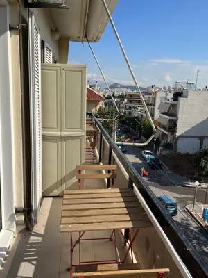 a balcony with a wooden bench on a building at Acropolis View in Athens