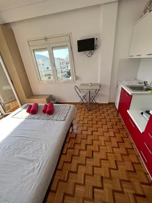 a bedroom with a bed with red pillows on it at Acropolis View in Athens