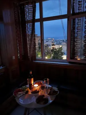 two plates of food on a table in front of a window at Acropolis View in Athens