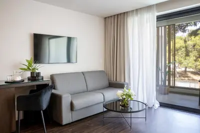 a living room with a couch and a table at Azur Hotel in Athens