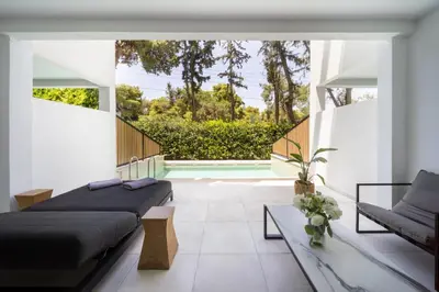 a bedroom with two beds and a pool at Azur Hotel in Athens