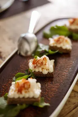 a plate with four pieces of food on it at Azur Hotel in Athens