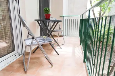 a balcony with two chairs and a table with a plant at Quality Home in Athens in Athens