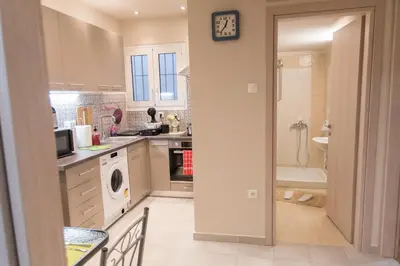 a kitchen with a sink and a washing machine at Quality Home in Athens in Athens