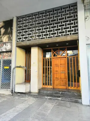 a building with a large wooden door on a street at Quality Home in Athens in Athens