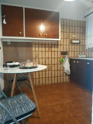 a small kitchen with a table and a counter at Violet Bedroom and Apartment in Spáta