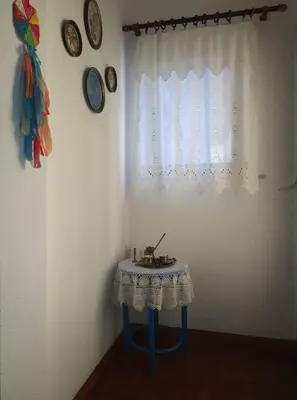 a small table in a room with a window at Violet Bedroom and Apartment in Spáta