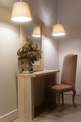 a room with a table and a chair and a mirror at Mikelina Boutique Hotel in Pallíni