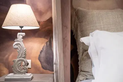 a lamp sitting on a table next to a bed at Mikelina Boutique Hotel in Pallíni