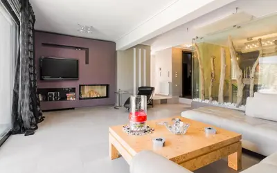 a living room with a couch and a table at Adam & Eve Villas in Sounio