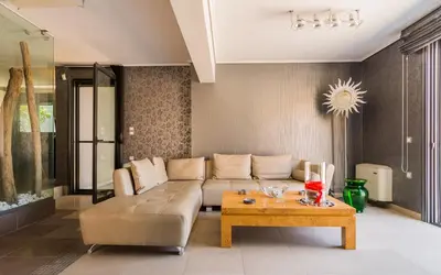 a living room with a couch and a coffee table at Adam & Eve Villas in Sounio