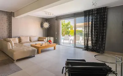 a living room with a couch and a table at Adam & Eve Villas in Sounio