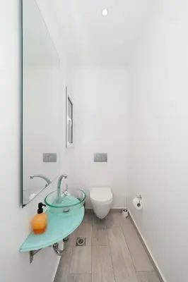 a bathroom with a glass sink and a toilet at Spacious Modern Apartment in Athens near Metro in Athens