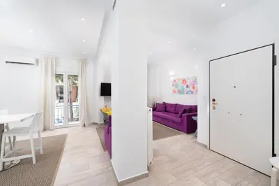 a living room with a purple couch and a mirror at Spacious Modern Apartment in Athens near Metro in Athens