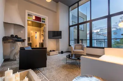 a living room with a fireplace and a tv at Soho Apartments in Athens