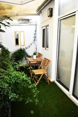 a patio with a table and chairs on a balcony at Soho Apartments in Athens