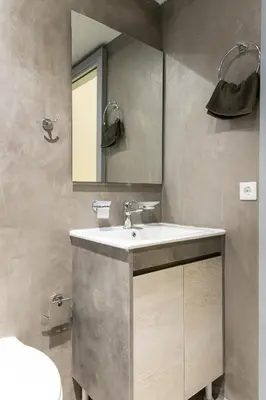 a bathroom with a sink and a mirror at Soho Apartments in Athens