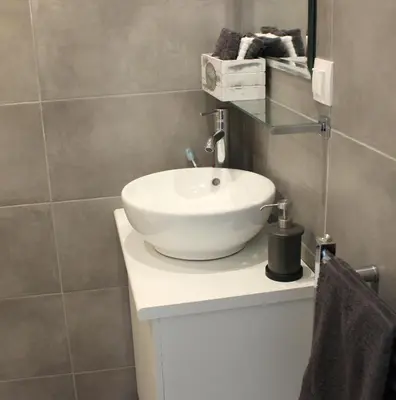 a bathroom with a white bowl sink on a counter at Adrianou 150 in Athens