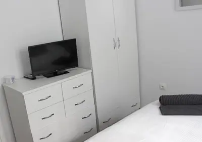 a bedroom with a tv on a white dresser at Adrianou 150 in Athens