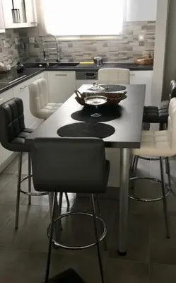 a kitchen with a table with chairs and a tableasteryasteryasteryasteryasteryastery at Adrianou 150 in Athens