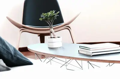 a chair and a table with a potted plant on it at Athens Grand Suite in Athens