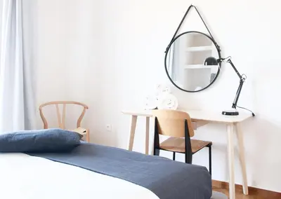 a bedroom with a bed and a desk with a mirror at Athens Grand Suite in Athens