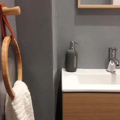 a bathroom with a soap dispenser on a sink at Athens Grand Suite in Athens