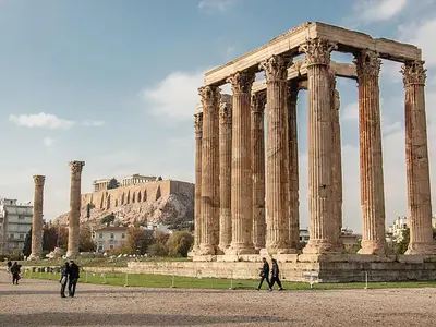 a group of people walking in front of an ancient building at Athens Grand Suite in Athens