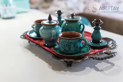 a tray with four green tea cups on a table at Orianna Apartment Airport by Airstay in Spáta