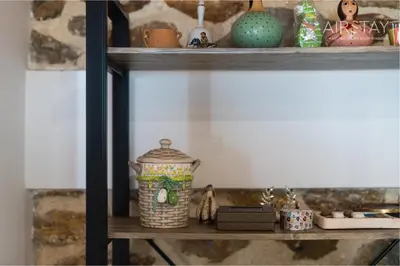 a shelf with a vase and other items on it at Orianna Apartment Airport by Airstay in Spáta
