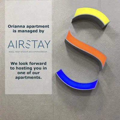 a sign for an embassy with a blue and orange logo at Orianna Apartment Airport by Airstay in Spáta