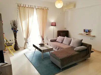 a living room with a couch and a table at Fotini's place! in Athens