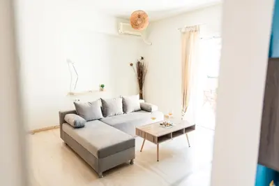 a living room with a couch and a table at Fotini's place! in Athens