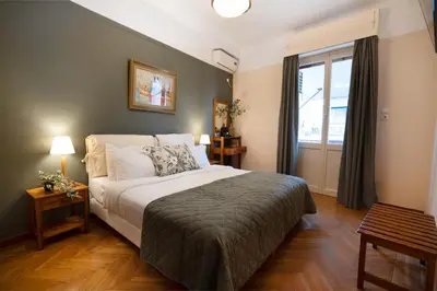 a bedroom with a large bed and a window at Art Gallery Hotel in Athens