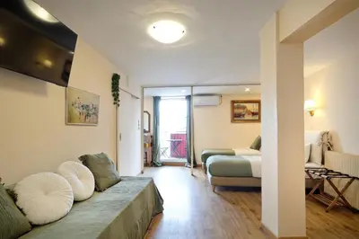 a living room with a couch and a bed at Art Gallery Hotel in Athens