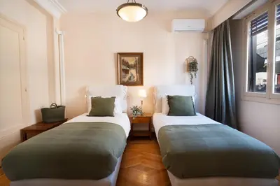 two beds sitting in a room with a window at Art Gallery Hotel in Athens