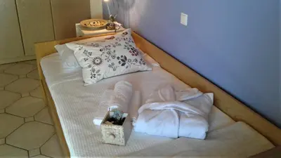 a bed with white sheets and pillows in a room at Villa 