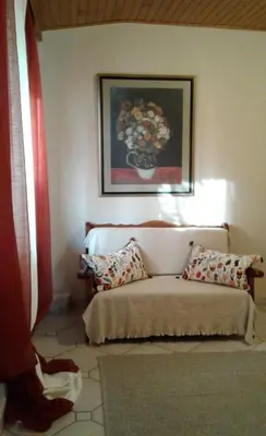 a bedroom with a bed and a painting on the wall at Villa 