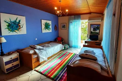 a bedroom with two beds and a tv in it at Villa 