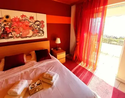 a bedroom with a bed and a large window at Villa 