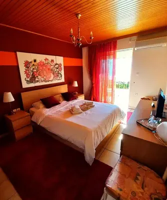 a bedroom with a large bed and a window at Villa 